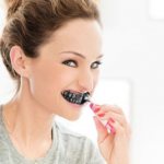 Brushing teeth with activated carbon